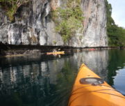 Kayak beneath limestone cliffs